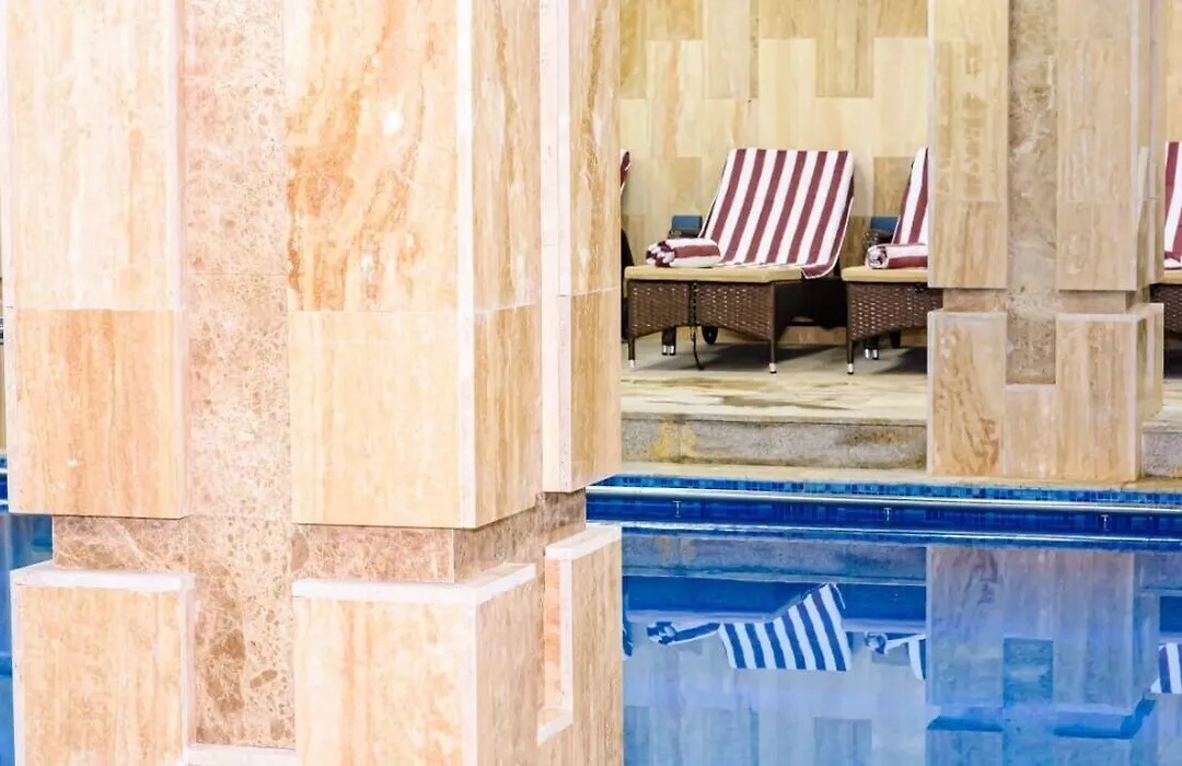 Indoor pool seen between marble columns