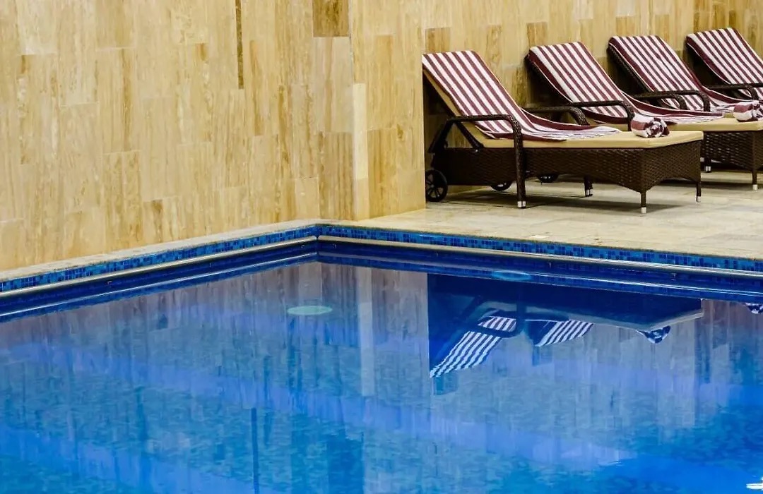 Indoor pool with loungers along the wall