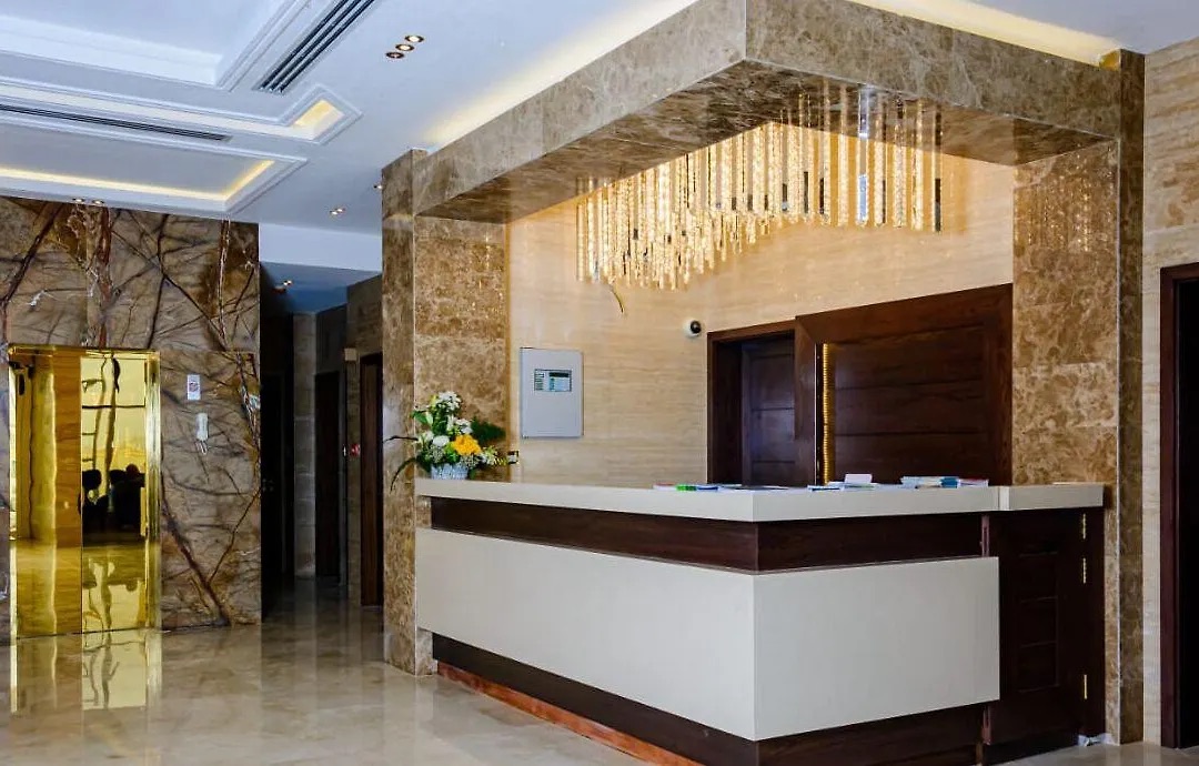 Reception desk in cream marble under a crystal chandelier
