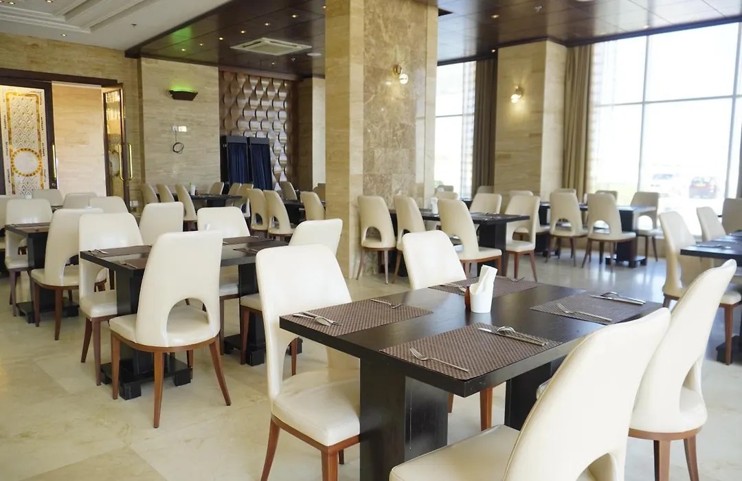 Silk Road Restaurant dining room with cream chairs and marble floors